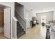Living area near stairs with neutral walls, tile flooring, and a decorative fireplace at 34429 Alameda Dr, Sorrento, FL 32776