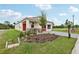 A view of single-Gathering home featuring stone accents, a well-manicured lawn and a gray paved driveway at 3495 Salvia Ct, Tavares, FL 32778