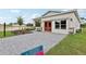 Single-Gathering home featuring stone accents, a well-manicured lawn and a gray paved driveway at 3495 Salvia Ct, Tavares, FL 32778