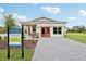 New construction featuring a welcoming facade with stone accents and a neatly paved driveway at 3495 Salvia Ct, Tavares, FL 32778