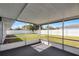 The screened-in patio features a textured floor and a large yard with a white fence at 3700 Sedgewick Pl, Orlando, FL 32806