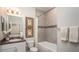 Bathroom featuring a bath tub and shower with decorative tile and a granite countertop vanity at 421 W Ariel Rd, Edgewater, FL 32141