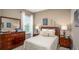 Cozy bedroom features a dresser, decorative items and a window with bright light at 421 W Ariel Rd, Edgewater, FL 32141