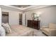 Elegant bedroom features a large dresser, a decorative mirror and a comfortable armchair at 421 W Ariel Rd, Edgewater, FL 32141