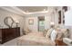 A lovely bedroom features a tray ceiling, decorative pillows, and a large dresser at 421 W Ariel Rd, Edgewater, FL 32141