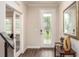 Foyer featuring a decorative front door, hard wood floors and decorative mirror at 421 W Ariel Rd, Edgewater, FL 32141