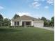 Charming single-story home with a well-manicured lawn and attached garage at 421 W Ariel Rd, Edgewater, FL 32141