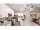 Modern kitchen with white cabinets, stainless steel appliances, and a large granite island at 421 W Ariel Rd, Edgewater, FL 32141