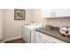 Functional laundry room with modern washer and dryer and storage at 421 W Ariel Rd, Edgewater, FL 32141