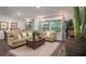 Cozy living room with neutral tones, wood floors, and lots of natural light at 421 W Ariel Rd, Edgewater, FL 32141