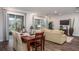 Open-concept living room and dining area features wood floors and plenty of natural light at 421 W Ariel Rd, Edgewater, FL 32141