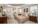 Elegant main bedroom featuring a tray ceiling, plush carpeting, and ensuite bathroom access at 421 W Ariel Rd, Edgewater, FL 32141