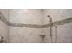 Updated shower with decorative tile accent and adjustable shower head at 421 W Ariel Rd, Edgewater, FL 32141