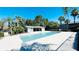 A sparkling community pool surrounded by ample patio space and lush tropical landscaping at 4759 S Texas Ave # 4759C, Orlando, FL 32839
