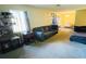Spacious living room featuring carpet flooring, a couch, and a dining area at 4759 S Texas Ave # 4759C, Orlando, FL 32839