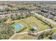 Aerial view of community green space and playground, with houses in the background at 569 Vista Sol Dr, Davenport, FL 33837