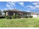 A lush green lawn with a screened-in lanai is perfect for enjoying the outdoors at 569 Vista Sol Dr, Davenport, FL 33837