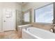 Bright bathroom featuring a soaking tub, glass shower, and natural light at 569 Vista Sol Dr, Davenport, FL 33837