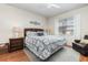 Comfortable bedroom featuring a queen-sized bed, a ceiling fan, and a window at 569 Vista Sol Dr, Davenport, FL 33837