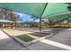 Close-up of covered bocce ball courts with concrete border, set in a serene community setting with shade at 569 Vista Sol Dr, Davenport, FL 33837