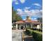 Welcoming community entrance with a Spanish-style tile roof and manicured landscaping at 569 Vista Sol Dr, Davenport, FL 33837