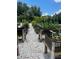 Community garden featuring raised garden beds with a gravel path in a well-maintained, natural setting at 569 Vista Sol Dr, Davenport, FL 33837