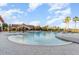 Large outdoor community pool with ample deck space and palm tree landscaping at 569 Vista Sol Dr, Davenport, FL 33837