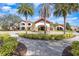Inviting entrance to the clubhouse surrounded by swaying palm trees at 569 Vista Sol Dr, Davenport, FL 33837