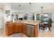 Open-concept kitchen with stainless steel appliances, granite countertops, and view to the living room at 569 Vista Sol Dr, Davenport, FL 33837