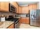 Modern kitchen featuring stainless steel appliances and granite countertops at 569 Vista Sol Dr, Davenport, FL 33837