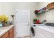 Functional laundry room with modern appliances and ample storage space at 569 Vista Sol Dr, Davenport, FL 33837