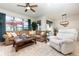 Bright living room with a comfortable sectional, chair and large windows at 569 Vista Sol Dr, Davenport, FL 33837