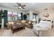 Open-concept living room featuring a cozy sectional sofa and large windows at 569 Vista Sol Dr, Davenport, FL 33837
