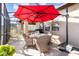 Inviting screened patio with dining area under a red umbrella and comfortable seating at 569 Vista Sol Dr, Davenport, FL 33837