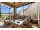 Relaxing screened patio with comfortable seating, ceiling fan, and view of the backyard at 569 Vista Sol Dr, Davenport, FL 33837