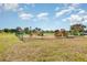 Community playground features slides and climbing structures surrounded by a safety fence on a sunny day at 569 Vista Sol Dr, Davenport, FL 33837