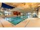 Indoor swimming pool with plenty of natural light, multiple lanes, and access ladder at 569 Vista Sol Dr, Davenport, FL 33837