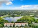 Aerial view of the community features mature landscaping, a pond with fountain, and well maintained buildings at 629 Dory Ln # 202, Altamonte Springs, FL 32714