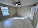 Bedroom with tile flooring, window, ceiling fan, and door to the bathroom at 629 Dory Ln # 202, Altamonte Springs, FL 32714