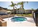 Community hot tub next to pool with palm trees and nearby buildings at 629 Dory Ln # 202, Altamonte Springs, FL 32714