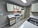 Bright kitchen features an electric range, white cabinets, and tile flooring at 629 Dory Ln # 202, Altamonte Springs, FL 32714