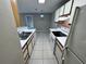 Efficient kitchen featuring white appliances, tile floor, and ample cabinet storage at 629 Dory Ln # 202, Altamonte Springs, FL 32714