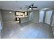 Open living space featuring tile floors, neutral paint, and kitchen access at 629 Dory Ln # 202, Altamonte Springs, FL 32714