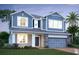 Charming two-story home featuring stone accents, a covered entryway, and a two-car garage at 726 Pointe Emerson Blvd, Apopka, FL 32703