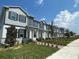 Street view of newly built homes with landscaped lawns and modern design at 726 Pointe Emerson Blvd, Apopka, FL 32703