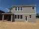 Exterior view of the back of a two-story home with many windows at 726 Pointe Emerson Blvd, Apopka, FL 32703