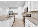 Modern kitchen with stainless appliances, granite countertops, and abundant cabinet space at 9158 Seascape Cv, Kissimmee, FL 34747