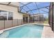 Private screened-in pool and spa with brick pavers, perfect for outdoor relaxation and entertaining at 9158 Seascape Cv, Kissimmee, FL 34747