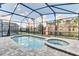 Inviting screened-in pool and spa area with well-maintained landscaping and a serene setting at 9158 Seascape Cv, Kissimmee, FL 34747