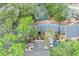 Aerial view of home featuring a lush, green landscape with a tennis court in a serene setting at 940 Douglas Ave # 132, Altamonte Springs, FL 32714